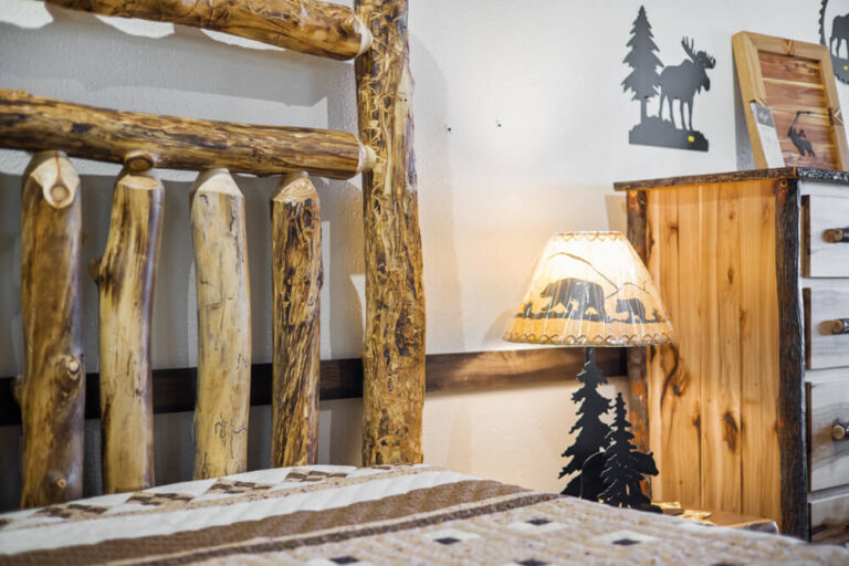 Nathan Satran log bed and lamp at west bench home furnishings