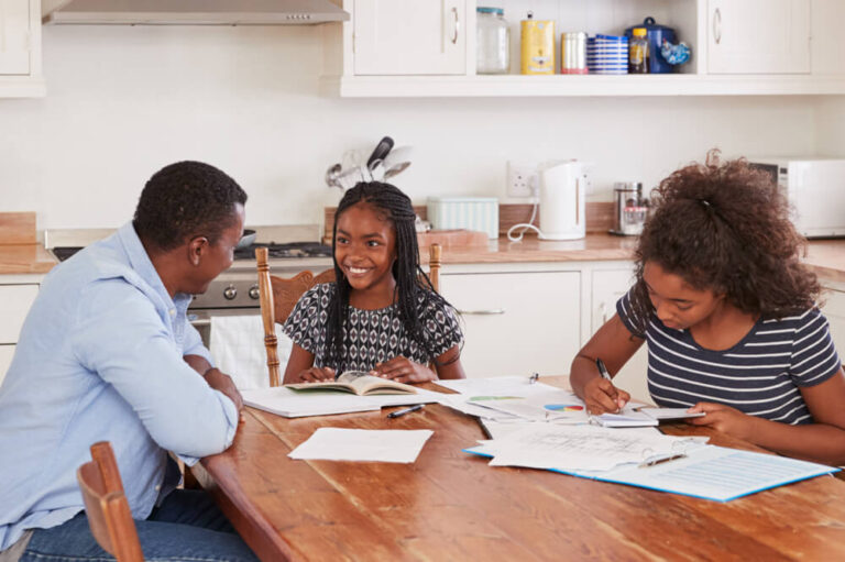 family sitting at a hardwood table